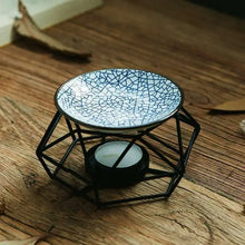 Copper oil burner with tealight holder for melting scented wax and diffusing essential oil fragrance in living spaces.