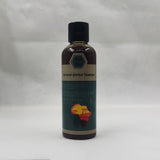 Crazy Growth Oil with Chebe Powder 100ml bottle side view on gray background.