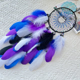 Decorative handmade dream catcher with colorful feathers for indoor wall hanging, bohemian decor, and peaceful bedroom decoration.