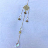 Decorative Hamsa sun catcher crystal hanger for home windows, reflective rainbow display, and symbolic decor styling.