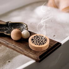 Decorative round wooden incense burner for burning incense during aromatherapy, home décor, and calming wellness routines.