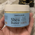 Dimollaure Organic Shea Butter Oil 100g jar held in hand for daily skin moisturizing and nourishing care.