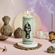 Elegua white 7 day candle in glass jar for spiritual offerings, altar work, and devotional ritual use.