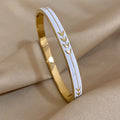 Enamel leaf stainless steel cuff bangle bracelet for everyday fashion wear and dressy styling.