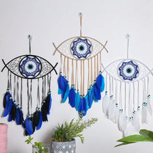 Evil Eye dream catcher with blue feathers wall hanging for bedroom decor, protection symbolism, and boho home styling.