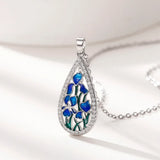 Floral blue enamel teardrop CZ necklace with pendant for special occasion styling, layering, and daily accessory wear.