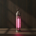 Glass and metal lantern in a tower shape with pink and clear glass panels