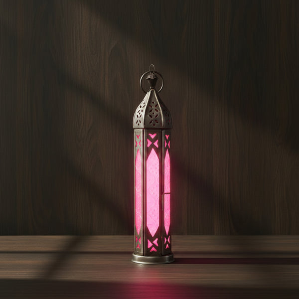 Glass and metal lantern in a tower shape with pink and clear glass panels
