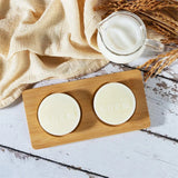 Goat Milk Silk Protein Soap bars on wooden board with cream container for daily brightening care.