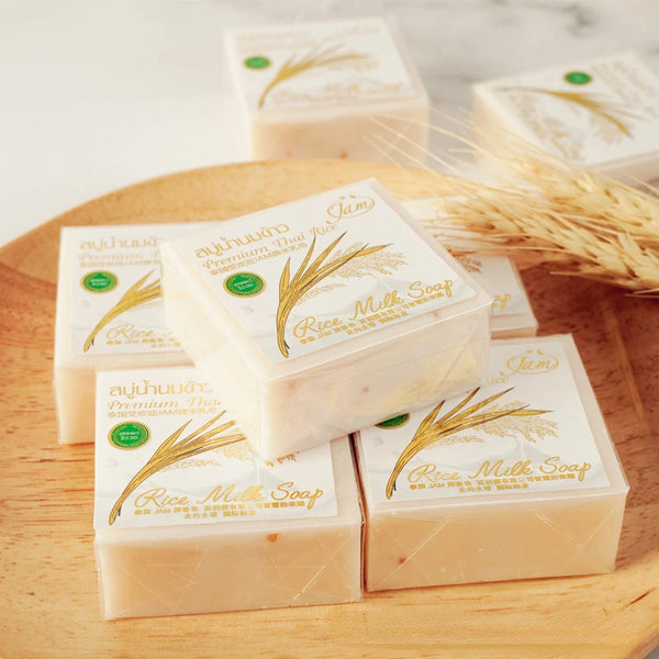 Gold JAM Thai Rice Milk Soap 65g bars with packaging on wooden surface for daily brightening cleanse.
