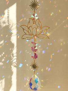 Golden Lotus Crystal Suncatcher prism ornament for hanging in windows, catching sunlight, and enhancing spiritual decor.