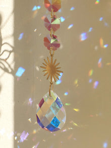 Golden Lotus Crystal Suncatcher window hanging with crystal accents for sun-catching, meditation room decor, and daily home styling.