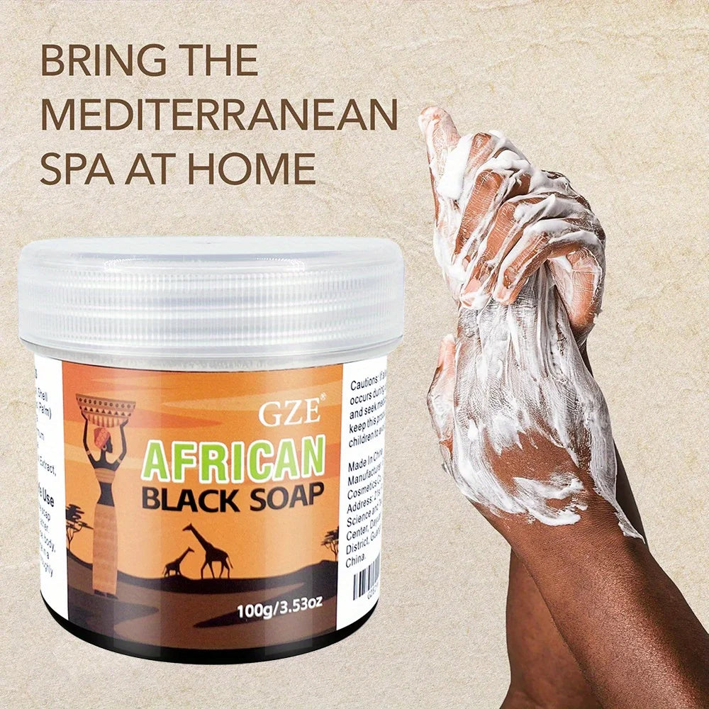 GZE African Black Soap 3-in-1 Cleanser hand applying soap lather on beige background showing texture.