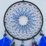 Handmade boho dream catcher with colorful feather accents for wall decor, bedroom beautifying, and nursery room styling.