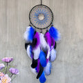 Handmade dream catcher wall hanging with colorful feathers for bedroom decor, nursery styling, and boho home decoration.