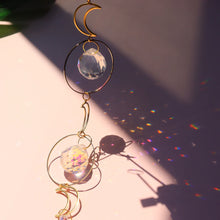 Hanging crystal prism sun catcher ball for window display, rainbow casting, and sunlit home decoration.