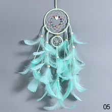 Hanging LED dreamcatcher with feather tassels for window decor, mood lighting, and spiritual home decoration.