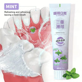Herbal Mint Toothpaste tube on dental-themed background for natural plaque prevention and whitening.