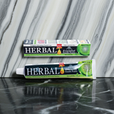 Herbal Essential Toothpaste tube for brushing teeth, freshening breath, and routine oral care.