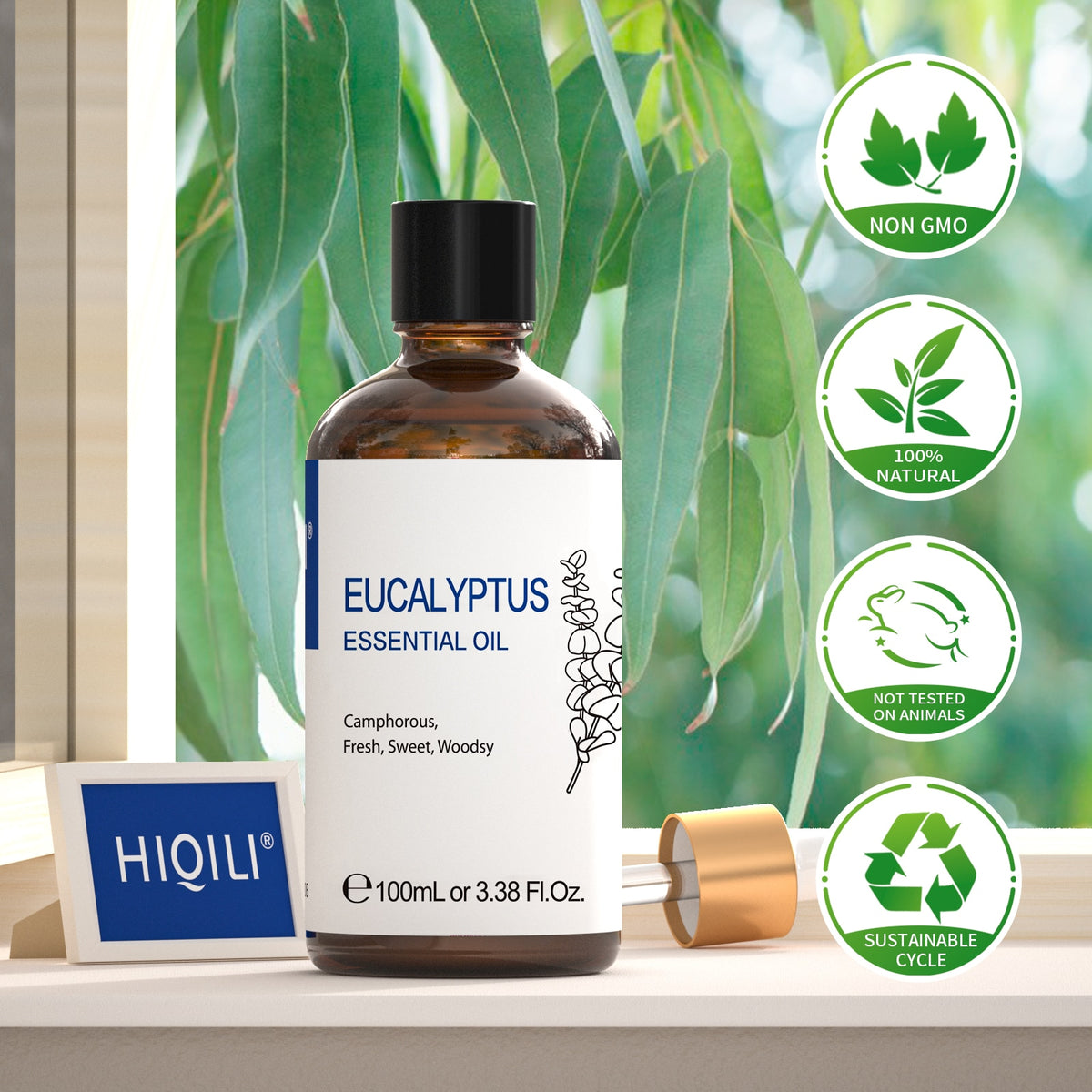 HIQILI Eucalyptus essential oil bottle beside eucalyptus foliage with non-GMO, natural and cruelty-free badges