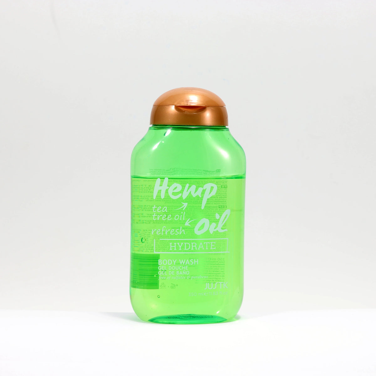 Justk Tea Tree Oil Hydrating Body Wash 350ml green bottle with copper cap on white background.