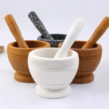 Kitchen resin mortar and pestle set for crushing garlic, herbs, and dry spices during meal preparation.