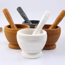 Kitchen resin mortar and pestle set for crushing garlic, herbs, and dry spices during meal preparation.