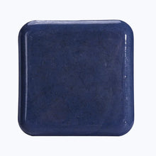 Kojic Acid & Sweet Orange Brightening Scrub Soap navy blue square bar tile on white background.