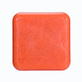 Kojic Acid & Sweet Orange Brightening Scrub Soap orange square bar tile on white background.