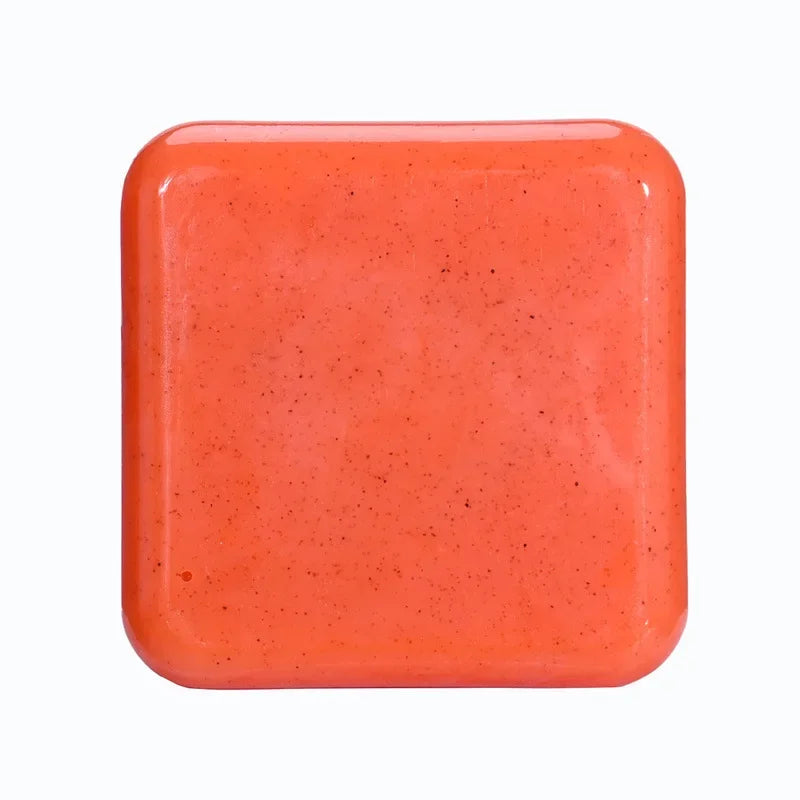 Kojic Acid & Sweet Orange Brightening Scrub Soap orange square bar tile on white background.