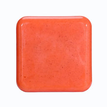 Kojic Acid & Sweet Orange Brightening Scrub Soap orange square bar tile on white background.