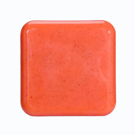 Kojic Acid & Sweet Orange Brightening Scrub Soap orange square bar tile on white background.