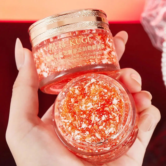 KUGE Dragon Blood Retinol Deep Moisture Face Cream two jars held by hand on red background.