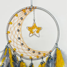 Large dream catcher with colorful feathers hanging ornament for wall display, room decoration, and boho interior styling.