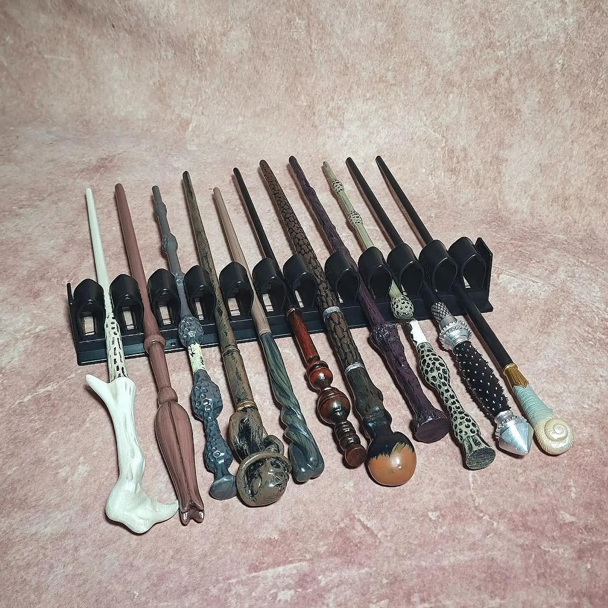 Magic wand display rack stand for presenting, storing, and organizing up to 11 collectible wands.