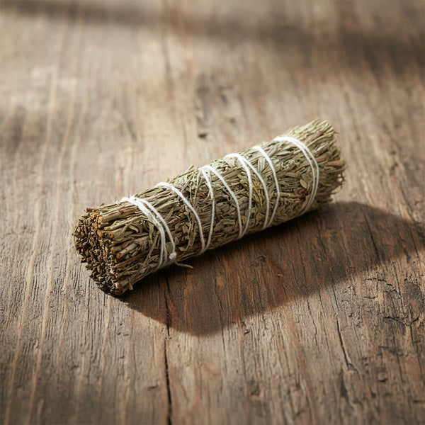 Meditation smudge stick with frankincense, myrrh, and white copal resin for spiritual cleansing rituals.