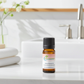Melissa Essential Oil bottle for calming aromatherapy, anxiety relief diffusing, and creating a soothing indoor atmosphere.