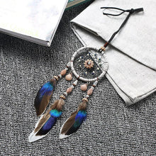 Mini Car Dream Catcher with natural feathers hanging ornament for car mirror decor, spiritual protection, and peaceful travel ambiance.
