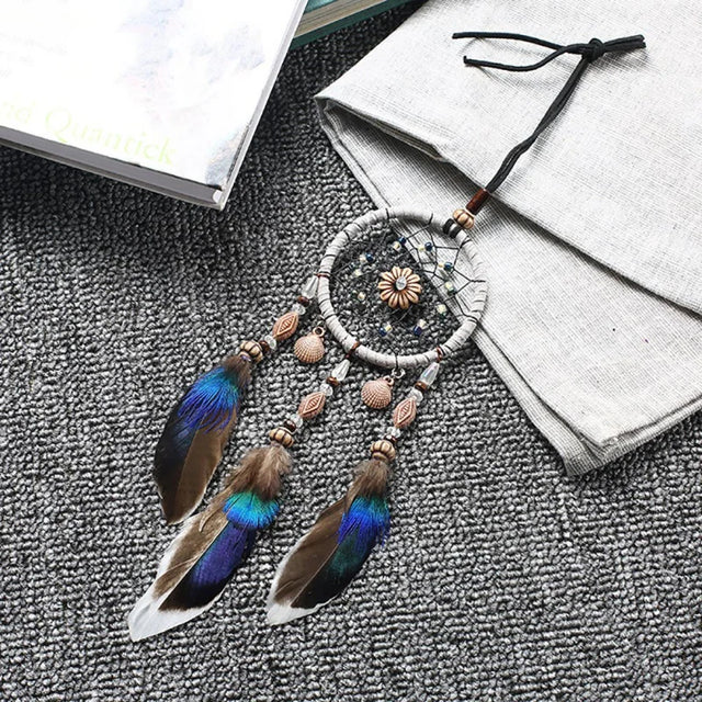 Mini Car Dream Catcher with natural feathers hanging ornament for car mirror decor, spiritual protection, and peaceful travel ambiance.