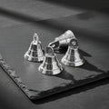 Mini chrome plated brass bell in silver, half inch, for ritual bell ringing, altar use, and energy clearing.