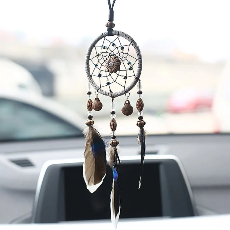 Mini dream catcher car accessory with natural feathers for mirror hanging, boho car styling, and calming road trip decor.