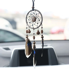 Mini dream catcher car accessory with natural feathers for mirror hanging, boho car styling, and calming road trip decor.