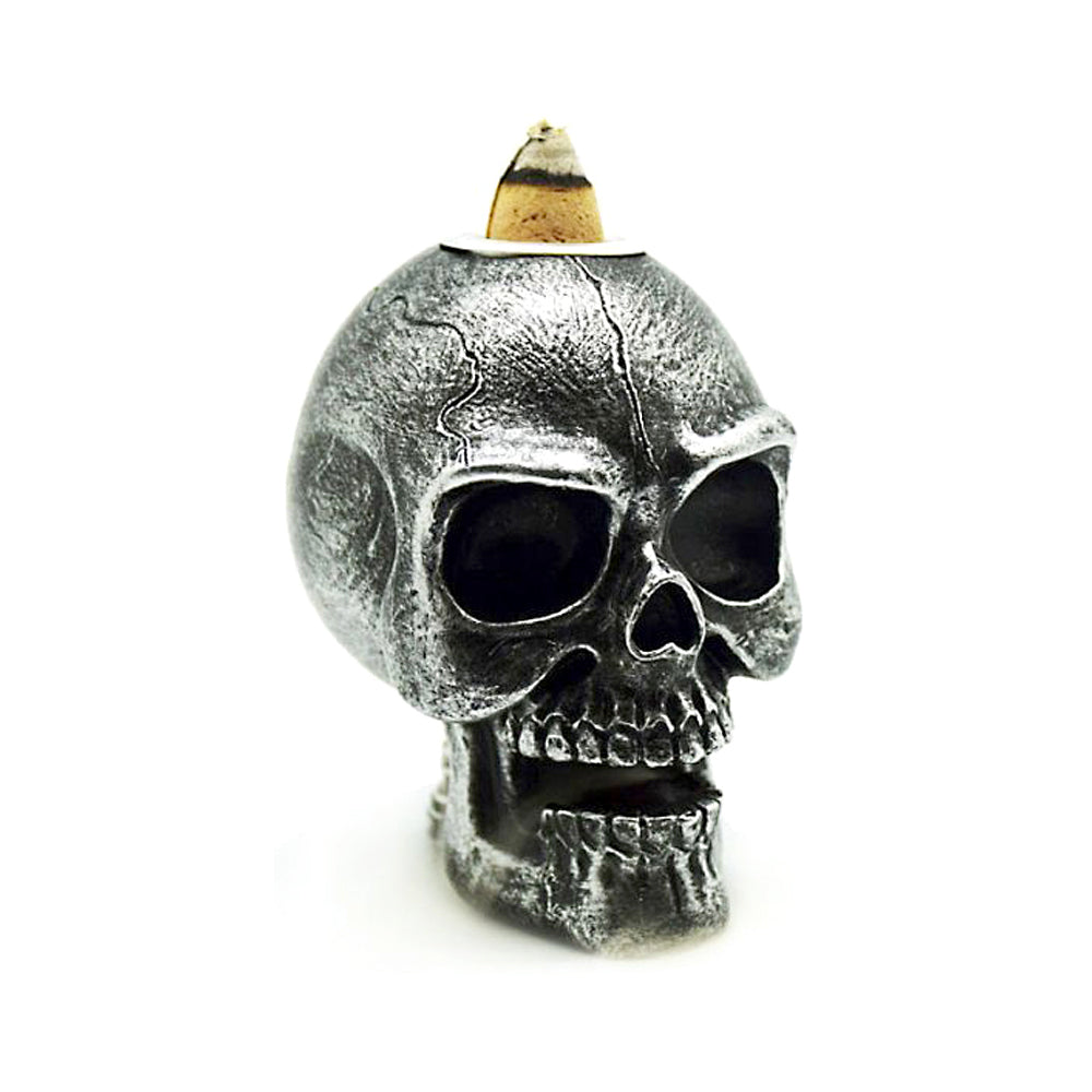 Mini silver skull backflow incense burner for cascading smoke effect, gothic decor, and meditation ambiance.