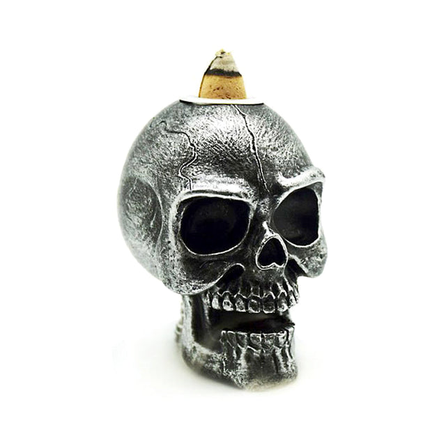 Mini silver skull backflow incense burner for cascading smoke effect, gothic decor, and meditation ambiance.
