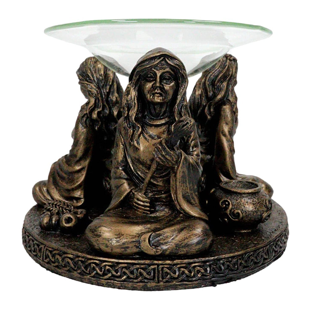Mother Maiden Crone oil burner lit for evening aromatherapy and ritual ambiance.