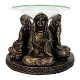 Mother Maiden Crone oil burner lit for evening aromatherapy and ritual ambiance.