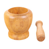 Natural bamboo mortar and pestle bowl for crushing herbs, spices, and aromatics during food prep.