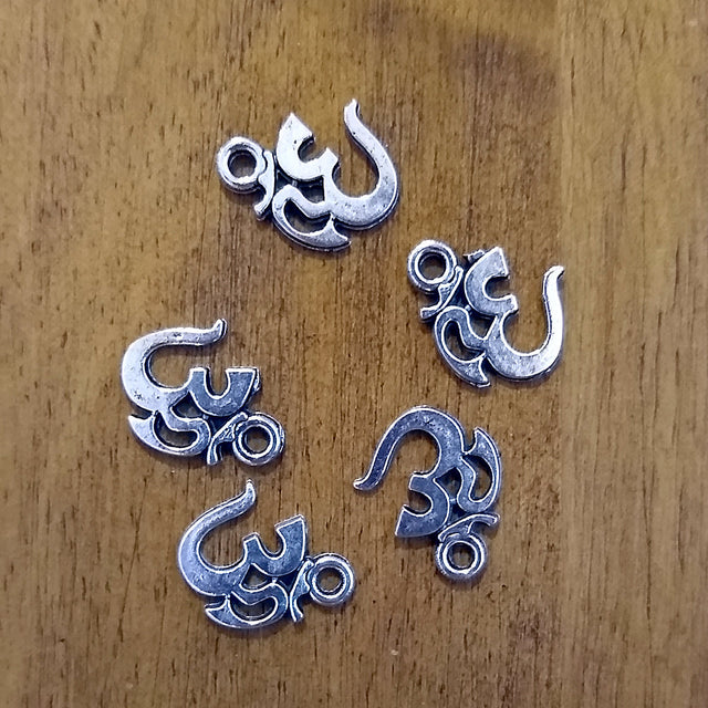 Om charm in red for jewelry making, meditation malas, and spiritual accessories.