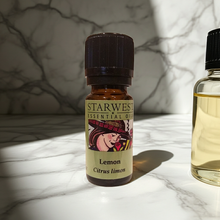 Starwest Botanicals organic lemon essential oil bottle for natural cleaning, aromatherapy blending, and invigorating home scenting.