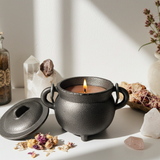 Palo Santo cauldron candle in cast iron holder for spiritual cleansing, blessing, and ceremonial practice.